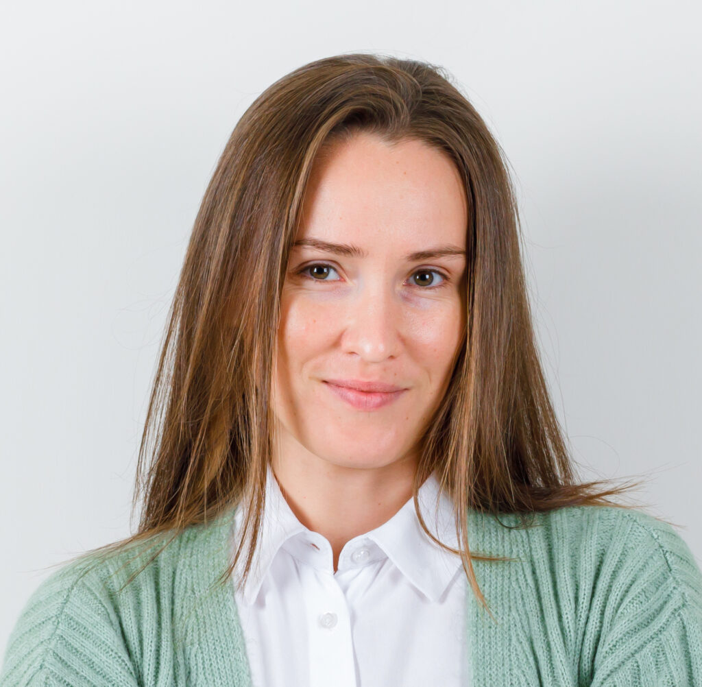 portrait of young lady keeping arms folded in blouse, cardigan a